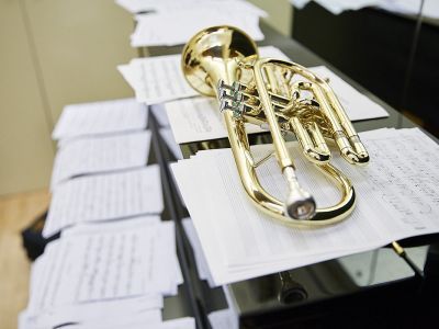 trumpet lying on lots of sheet music